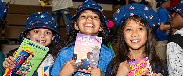 3 children holding books
